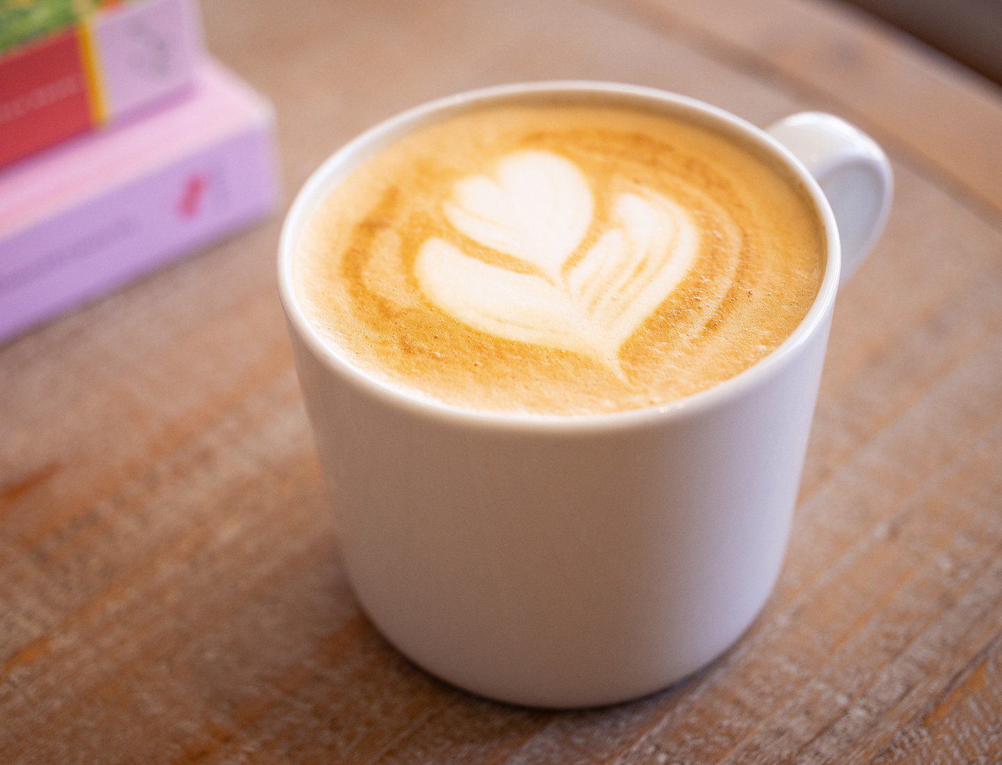 Latte with a flower design made of creamer.