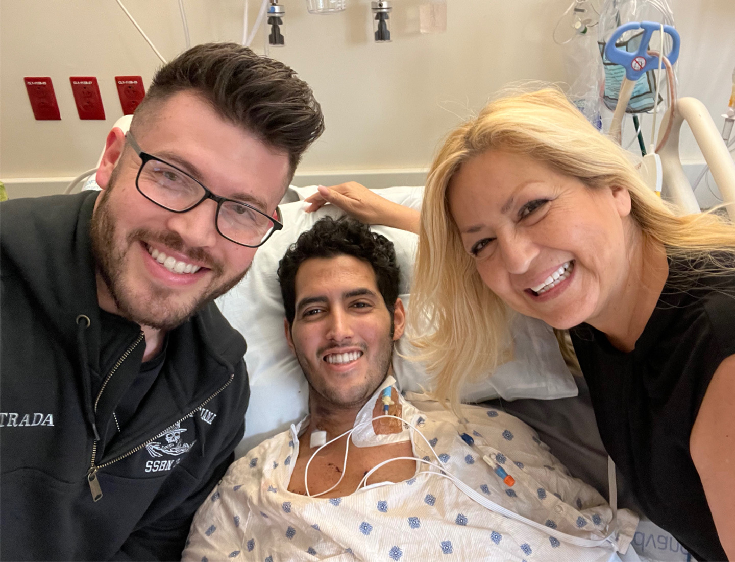 Abraham surrounded by his brother and mother in the the hospital.