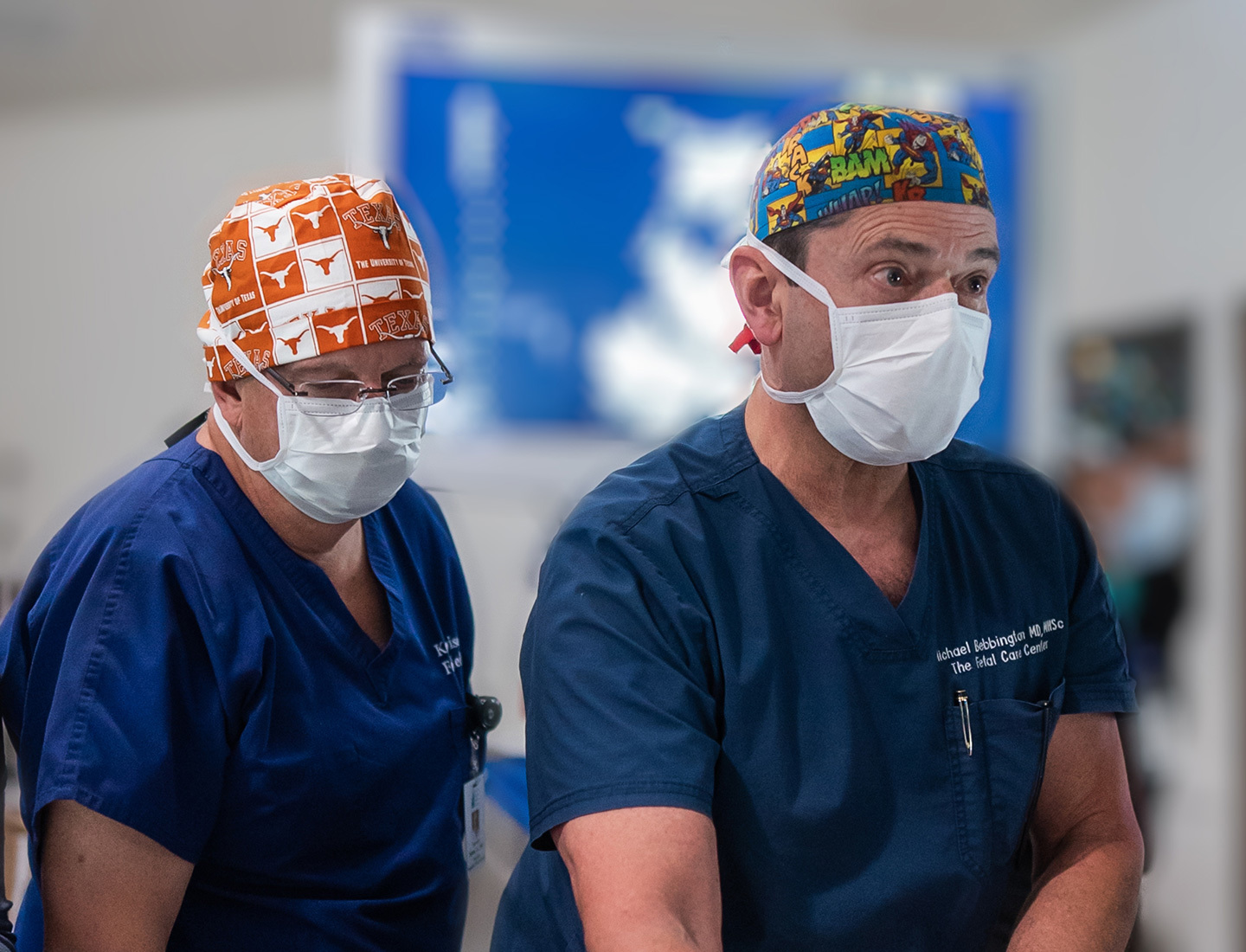 Kenneth Moise, MD and Richard Bebbington, MD in scrub caps and masks prepare for twin twin laser in utero surgery.
