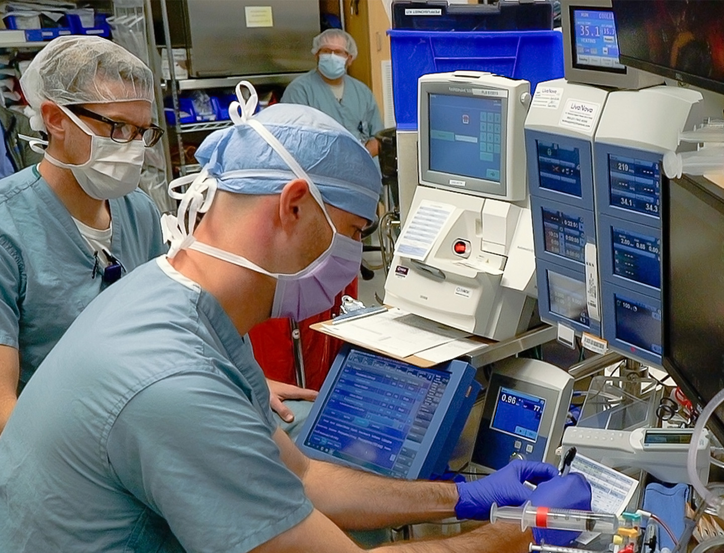A perfusionist adjusts equipment during a pediatric heart surgery.