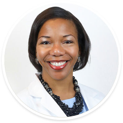 Headshot of Dr. Yvette Williams-Brown smiling in a white coat with a black necklace.