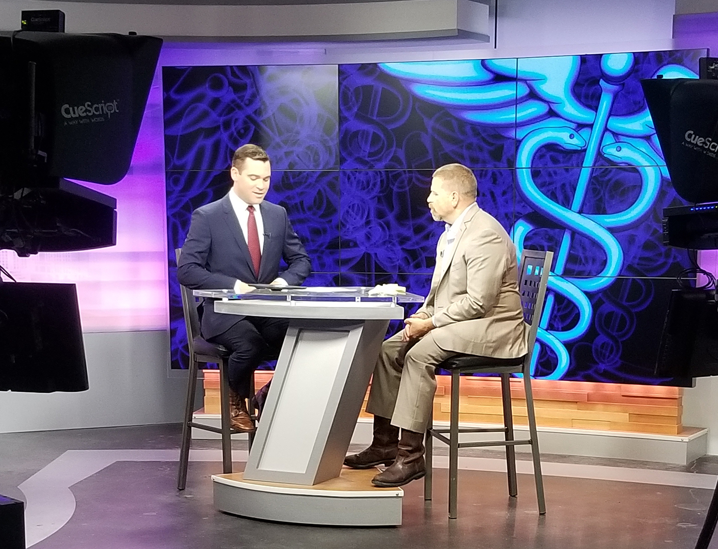 Karl Koenig, MD, FAOA, FAAOS, FAAHKS, Medical Director at the Musculoskeletal Institute, speaks with a reporter in this screengrab from a TV news story.